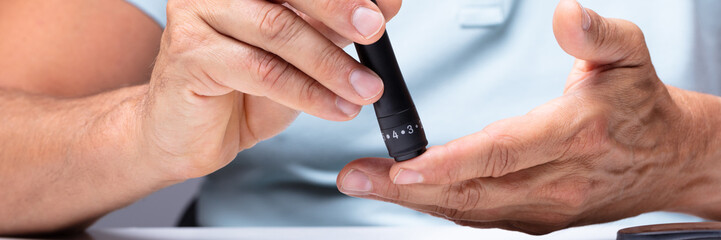 Man Testing High Blood Sugar With Glucometer