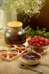 Morning table Breakfast Tea, raspberry jam, fresh berries