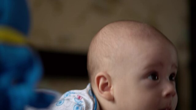 Newborn Active Baby Cute Smiling Teethless Face Portrait Early Days On Stomach Developing Neck Control. 5 Months Child In Playpen Gnaws Toys Look At Camera. Infant, Childbirth, Beginning Concept