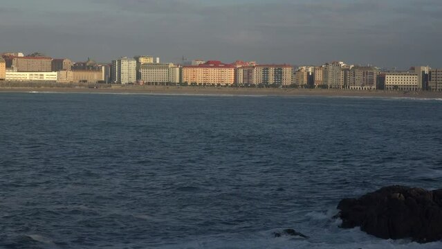Riazor beach in the city of A Coru&ntilde;a with early morning mist and rising sun
