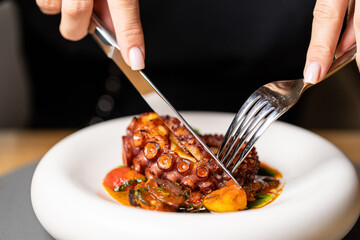 Grilled octopus with small potatoes with herbs and spices. Top view with space for your text