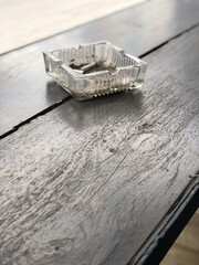 ashtray on wooden table, street view