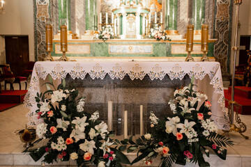 candles and flowers in a catholic church