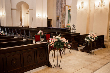 decor of flowers in the Catholic Church and wooden benches