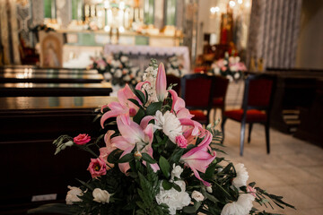decor of flowers in the Catholic Church and wooden benches
