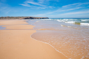 sandy bay Praia do Bordeira with outgoing waves, portugal coast algarve