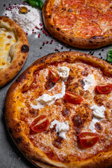 three delicious pizza on concrete, top view