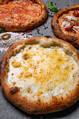 three delicious pizza on concrete, top view
