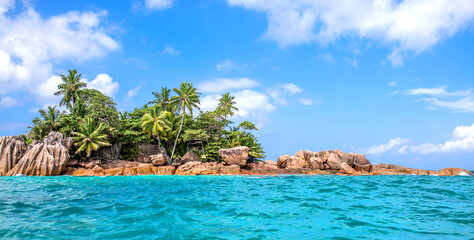 Beautiful island of Seychelles, granite cliffs of the beach with palm trees and azure water. Vacation concept travel holiday banner background. Hawaiian Islands Paradise Beach. Luxury travel.
