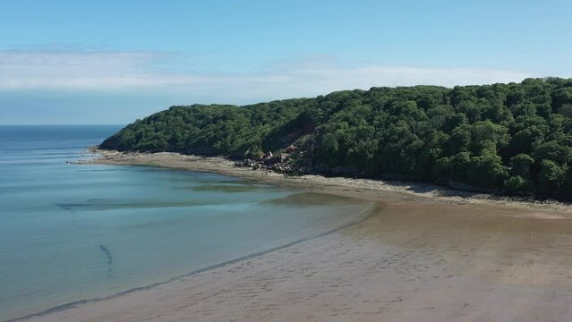 Oxwich Bay on the Gower peninsula in Swansea, UK, a long sweeping sandy bay with a shallow water line with easy access by road from Swansea attracts visitors from all over the UK