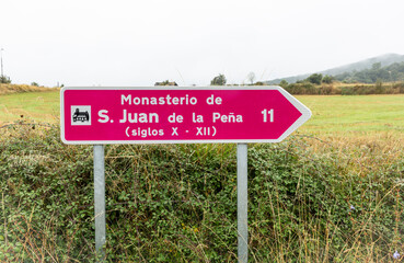 Obraz premium traffic signpost pointing the way to the Monastery of San Juan de la Peña, province of Huesca, Aragon, Spain 