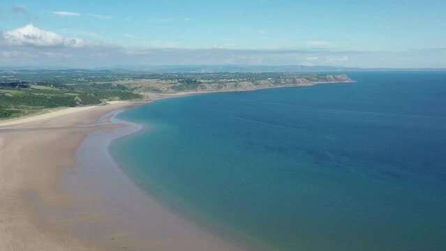 Oxwich Bay on the Gower peninsula in Swansea, UK, a long sweeping sandy bay with a shallow water line with easy access by road from Swansea attracts visitors from all over the UK