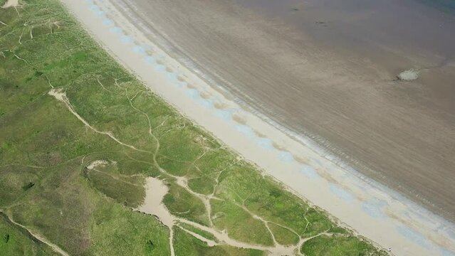 Oxwich Bay on the Gower peninsula in Swansea, UK, a long sweeping sandy bay with a shallow water line with easy access by road from Swansea attracts visitors from all over the UK