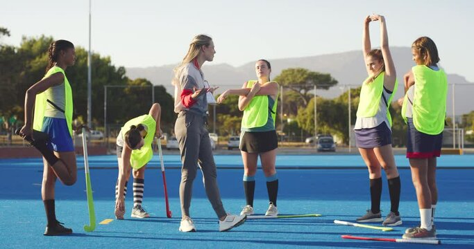 Group Of Hockey Players And Coach Talking Strategy Before Playing Game. Sports Trainer Standing In Front Of Team And Using Clipboard To Show And Teach Plan Before Match. Getting Ready To Win