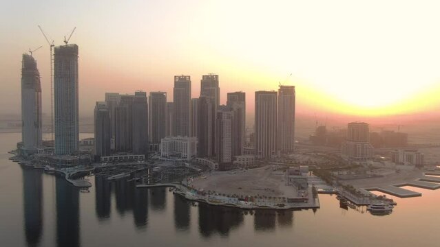 Aerial panoramic view of Dubai Vida Creek Harbour skyline with a mystic sunset sky view 