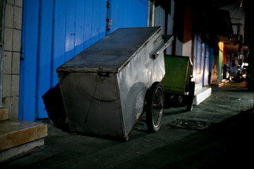 Street vendors cart in the sidewalk at night