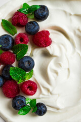 Breakfast, yogurt with fresh berries, raspberries and blueberries, on a white background, selective focus, no people, healthy food,