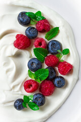 Breakfast, yogurt with fresh berries, raspberries and blueberries, on a white background, selective focus, no people, healthy food,