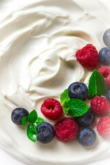 Breakfast, yogurt with fresh berries, raspberries and blueberries, on a white background, selective focus, no people, healthy food,