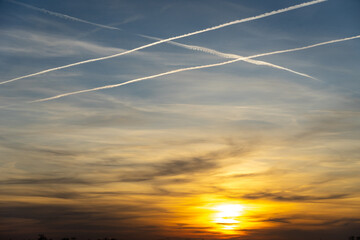 a beautiful atmospheric red sunset on a field with power poles