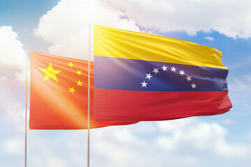 Sunny blue sky and flags of venezuela and china