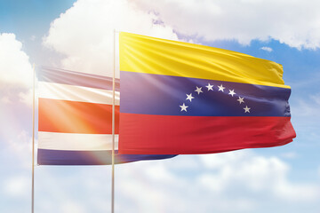 Sunny blue sky and flags of venezuela and costa rica