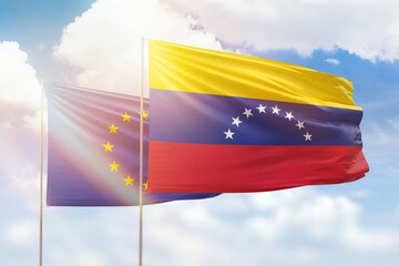 Sunny blue sky and flags of venezuela and european union