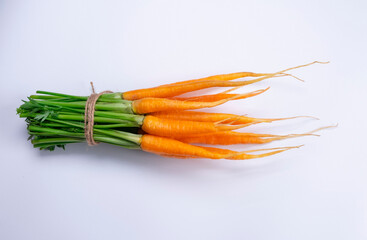  bunch of young carrots on a white background