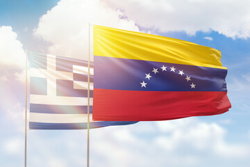 Sunny blue sky and flags of venezuela and greece