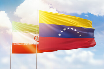 Sunny blue sky and flags of venezuela and iran