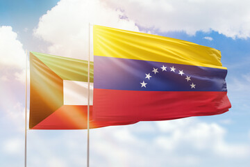 Sunny blue sky and flags of venezuela and kuwait