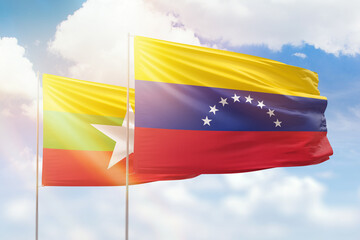 Sunny blue sky and flags of venezuela and myanmar