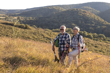 Active old woman and man walking at field and enjoy