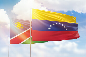 Sunny blue sky and flags of venezuela and namibia