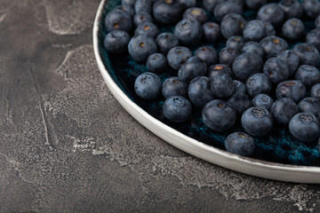 Blueberry. Ripe and fresh blueberries on a black textured background. Vitamins. Healthy food. Juicy berry. Copy space. Place for text