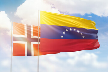 Sunny blue sky and flags of venezuela and norway