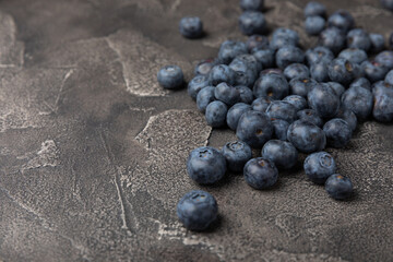 Blueberry. Ripe and fresh blueberries on a black textured background. Vitamins. Healthy food. Juicy berry. Copy space. Place for text