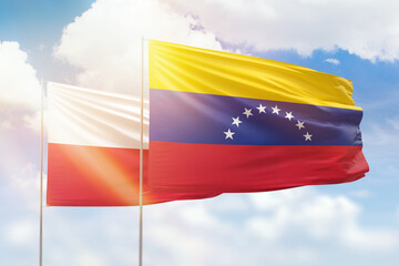 Sunny blue sky and flags of venezuela and poland