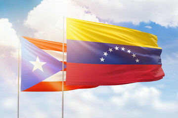 Sunny blue sky and flags of venezuela and puerto rico