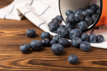 Blueberry. Ripe and fresh blueberries on brown texture background. Vitamins. Healthy food. Juicy berry. Copy space. Place for text