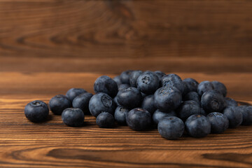 Blueberry. Ripe and fresh blueberries on brown texture background. Vitamins. Healthy food. Juicy berry. Copy space. Place for text