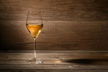 White wine glass on wooden background