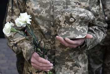 A funerals of Ukrainian servicemen killed during Russia's invasion of Ukraine. Soldier holds...