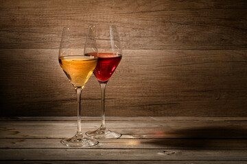 White and red wine glasses on wooden background