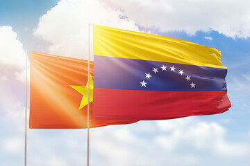 Sunny blue sky and flags of venezuela and vietnam