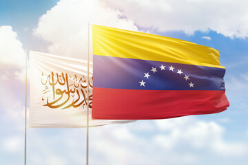 Sunny blue sky and flags of venezuela and afghanistan