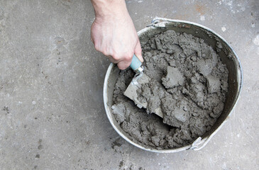 Mixing of concrete mortar.The builder prepares the cement mortar using a construction...