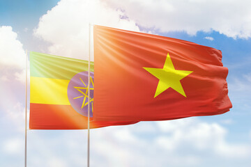 Sunny blue sky and flags of vietnam and ethiopia