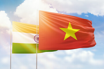 Sunny blue sky and flags of vietnam and india