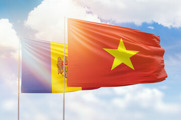 Sunny blue sky and flags of vietnam and moldova